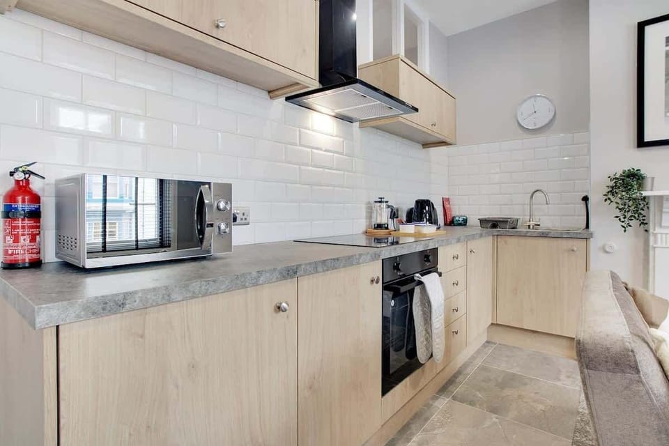 Kitchen equipped with all essentials, including a washer & dryer, oven, fridge and full cookware set.