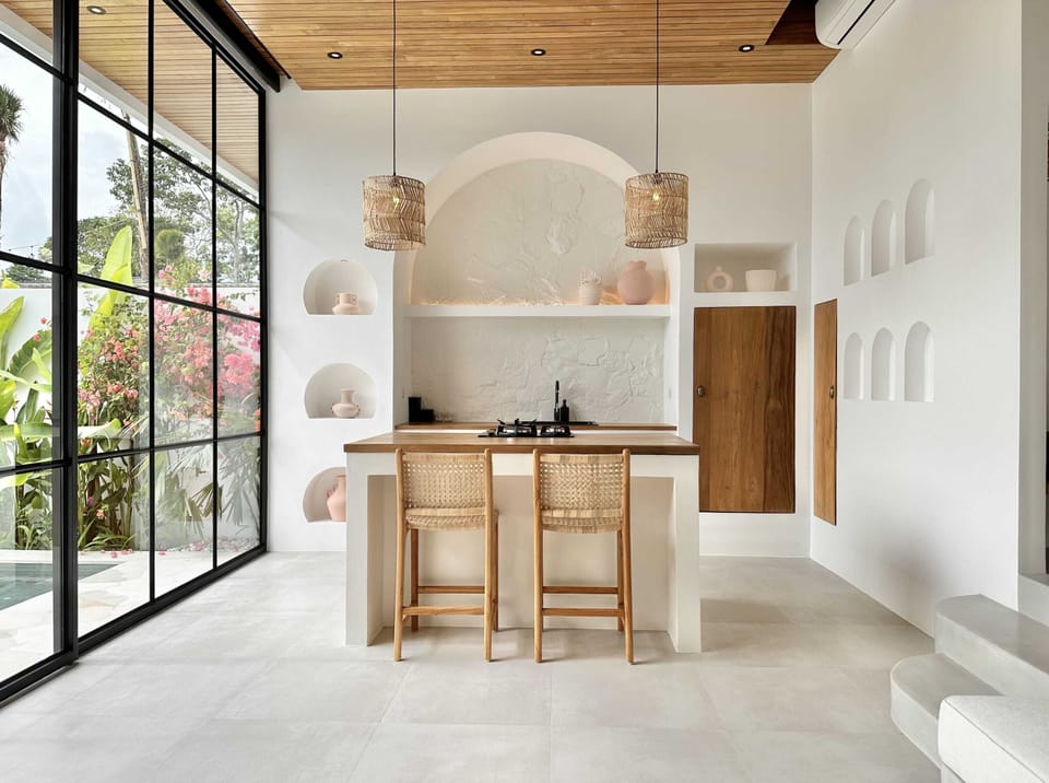Kitchen with a stove, oven, fridge, and a water dispencer