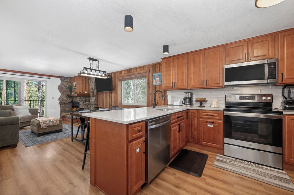 Your spacious kitchen features warm wood cabinets, modern appliances, and a central island perfect for cooking memorable meals during your stay.