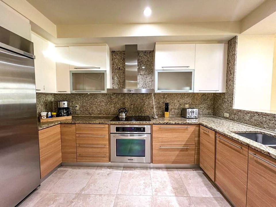 Kitchen: Wood-toned, flush cupboards and cabinets, with Melamine countertops

