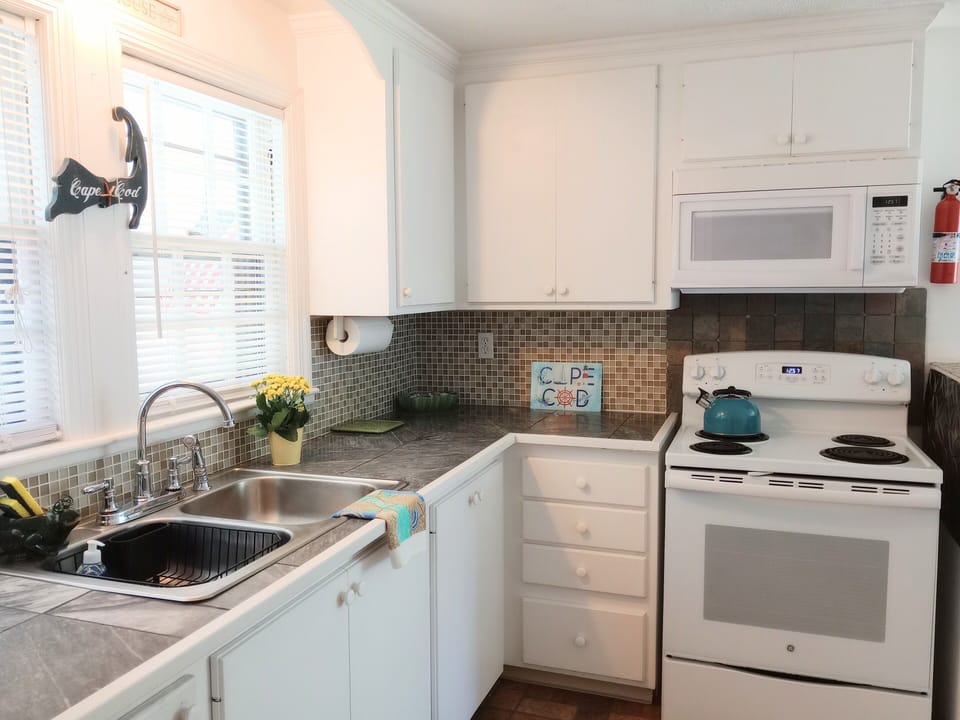 Spacious Fully equipped kitchen has utensils and dinnerware for every one! 