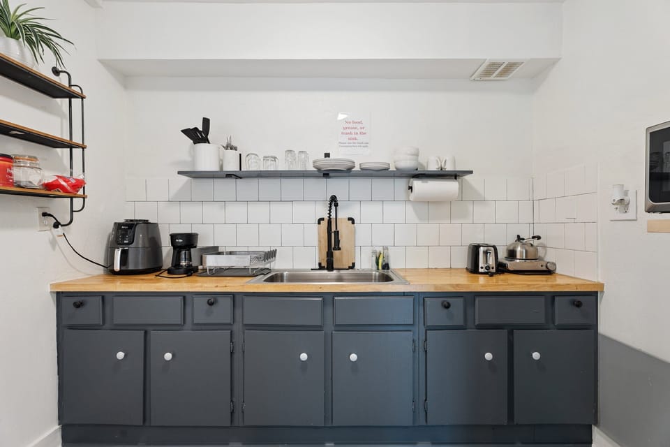 Compact kitchen with open shelving and essentials for simple, everyday cooking.