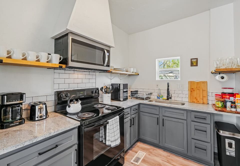 The kitchen’s warm lighting and homey touches make cooking feel like a comforting ritual