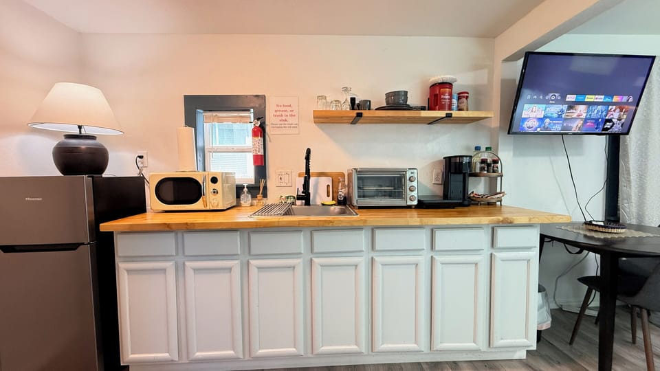 Everything you need is at your fingertips — a sink, drying rack, utensils, and small appliances all in one place.