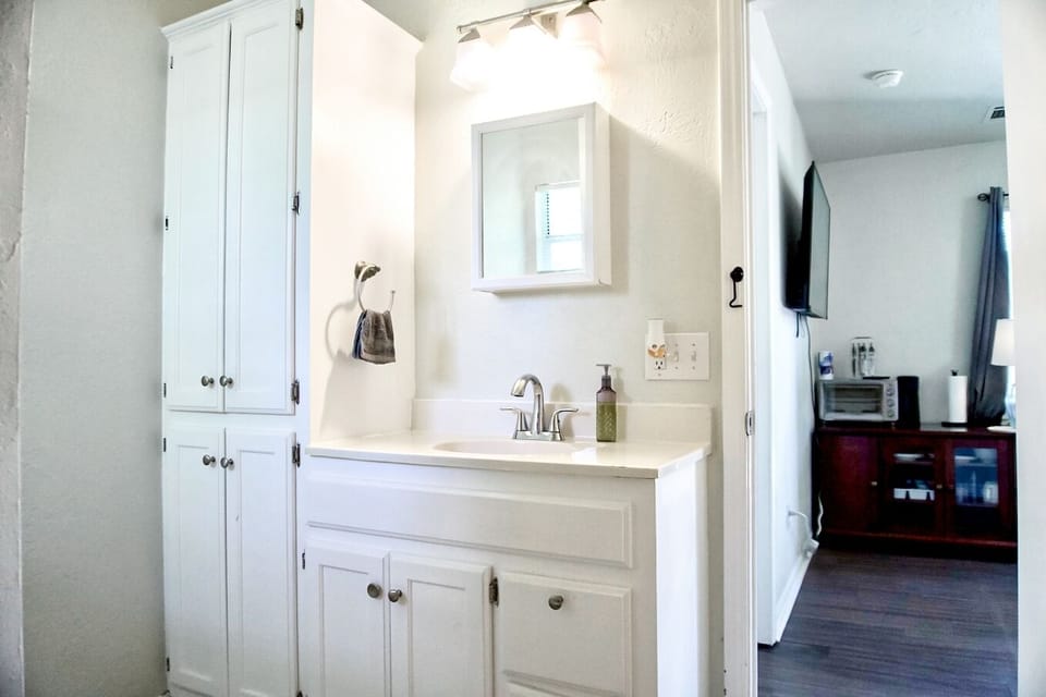 The bathroom provides a sleek, elegant space for unwinding in style