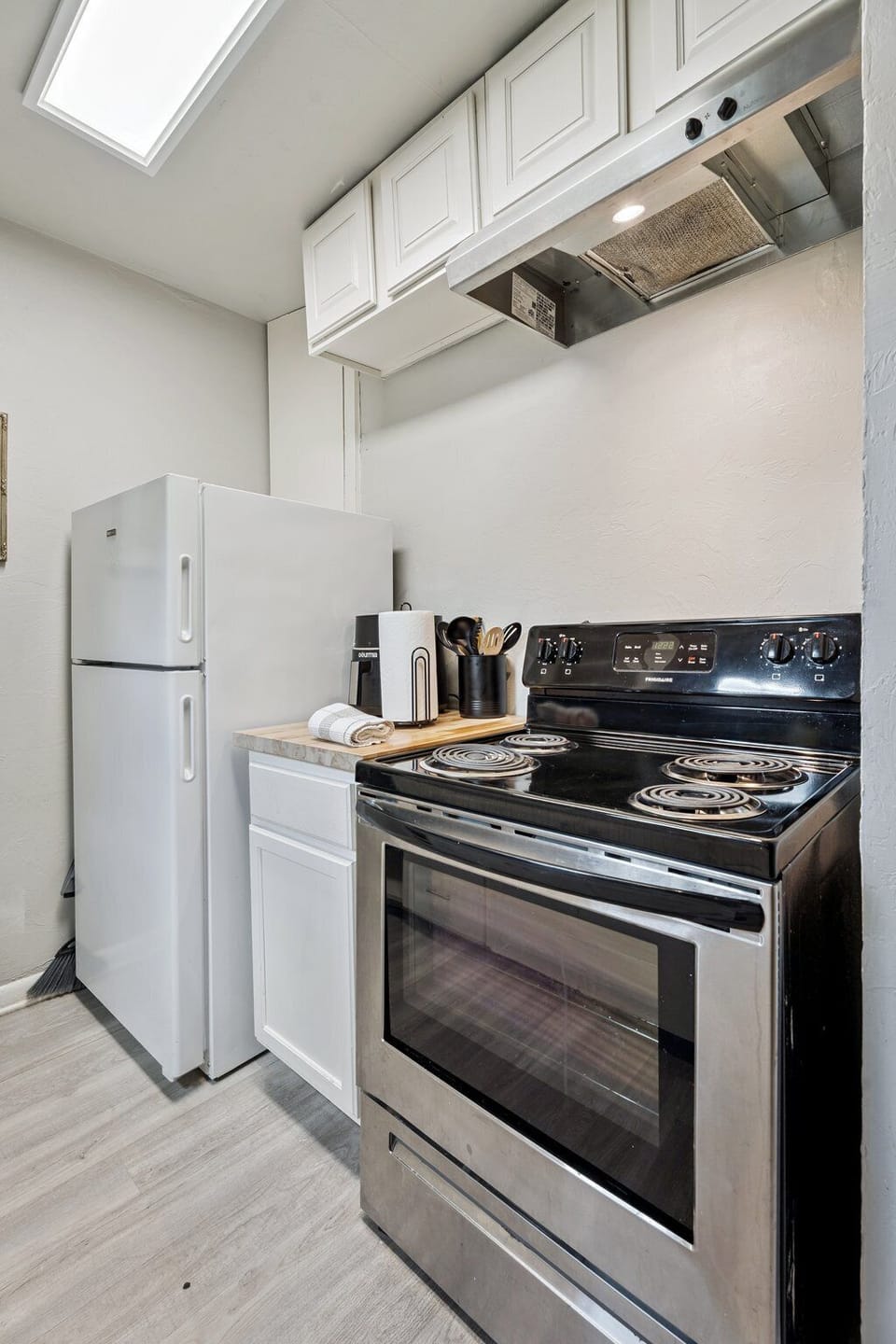 Prep with ease on butcher-block counters and enjoy the convenience of full-size appliances—including an air fryer!