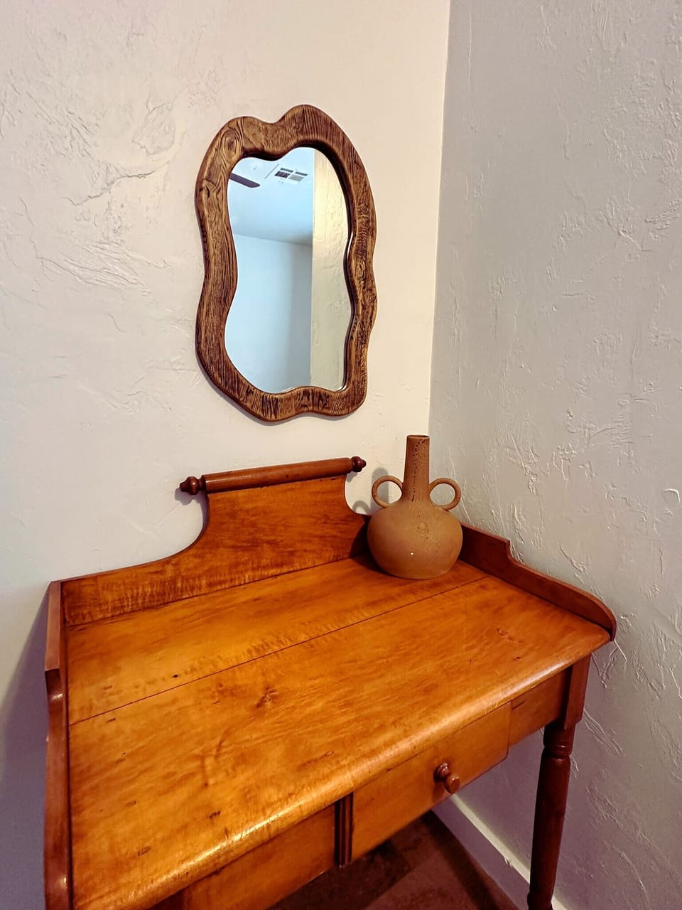 A Timeless Reflection: A Vintage Mirror Graces a Charming Corner