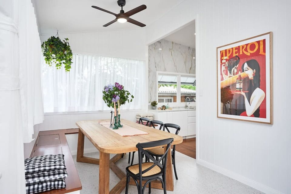 Dining room with big windows and big dining table. Very pretty space