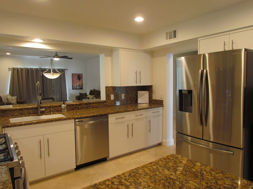 Another view of Kitchen.  Granite, Stainless, Pass-Through to Dining/Living