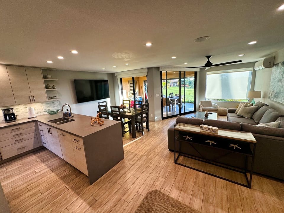 Ground floor.  Full kitchen, pull out sofa, large lanai indoor / outdoor tables.