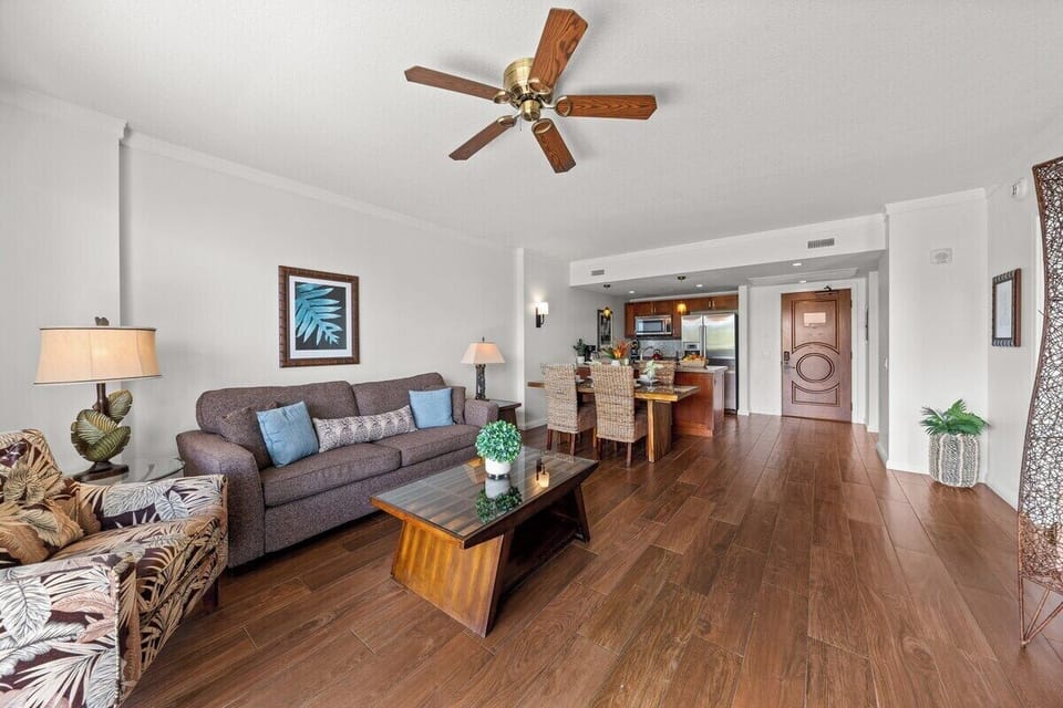 Bright living room with modern furniture and open layout leading to the kitchen