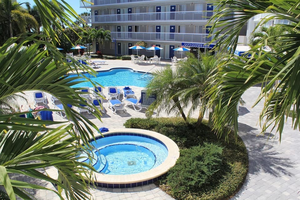 Float in the sparkling pool surrounded by tropical landscaping.