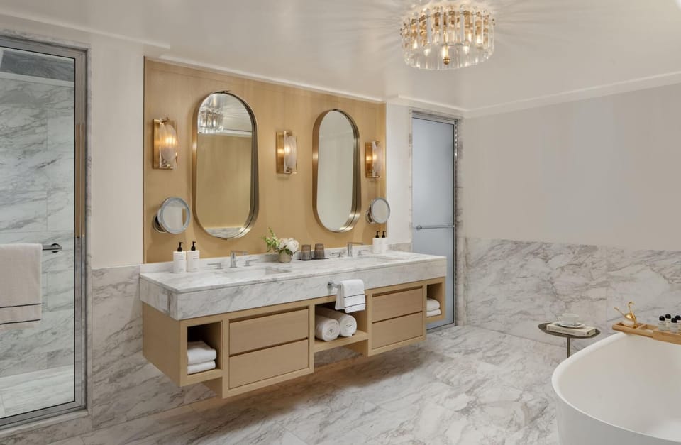 Refresh at the double vanity with glowing, upscale sconces.