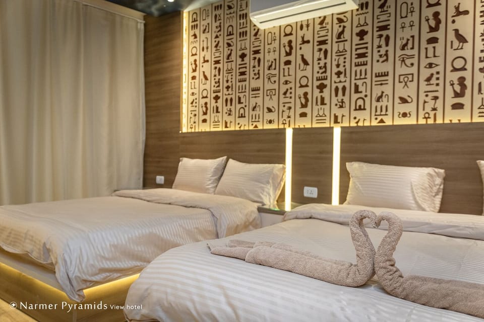 Bed wibackboards carved with ancient Egyptian hieroglyphic symbols light up