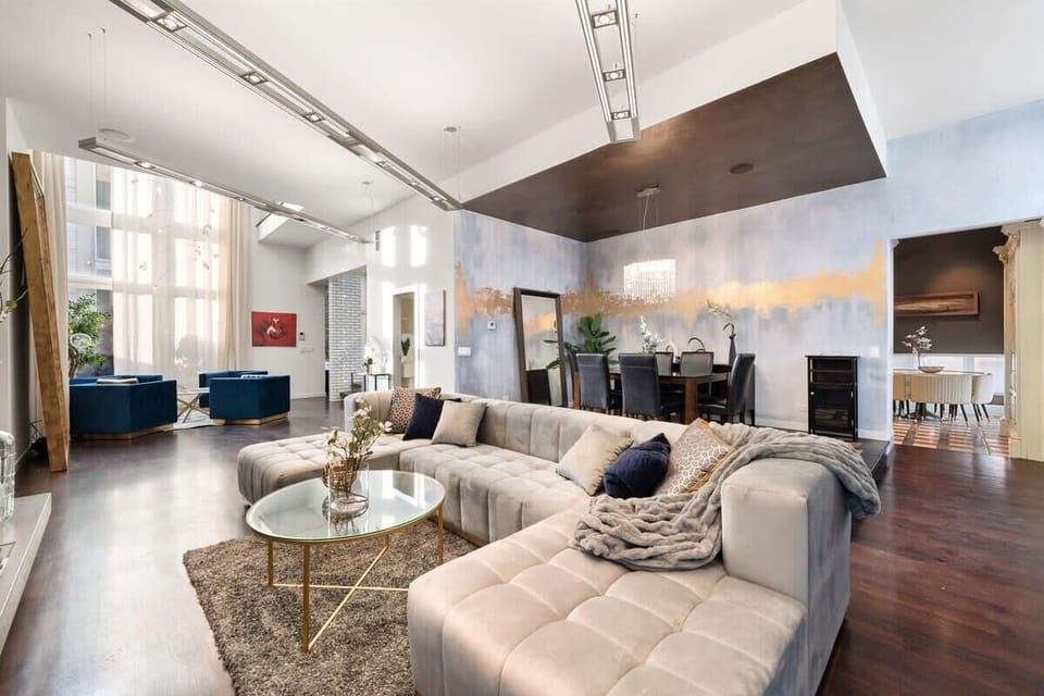 Bright, open living area w/ comfy seating and modern touches, perfect for relaxing or gathering after a full day out.