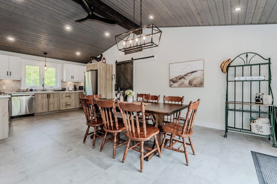 The kitchen table provides a beautiful escape from reality, including access. to the fully equipped kitchen. 