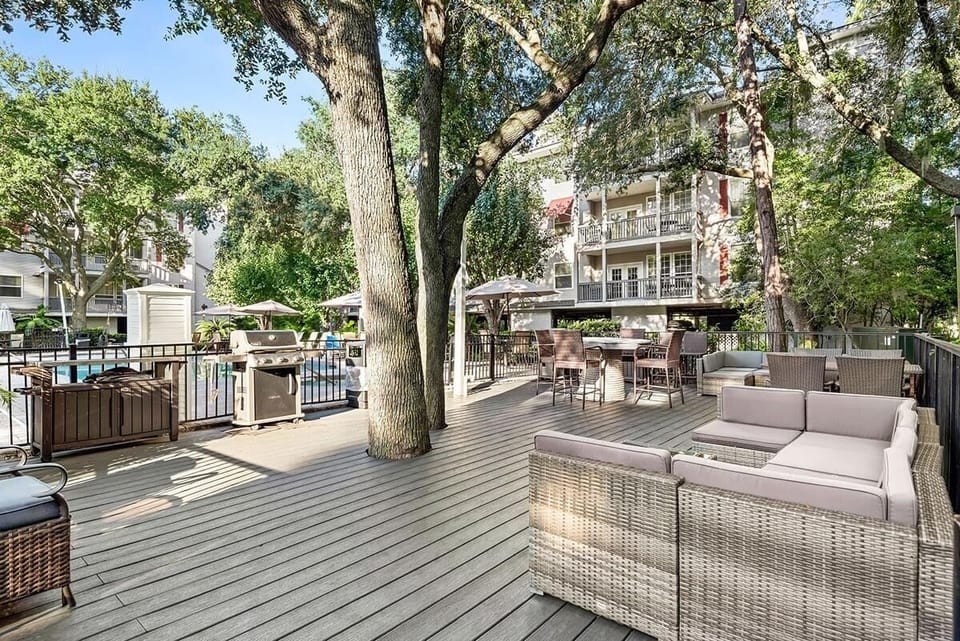 Outdoor deck by pool with grills.