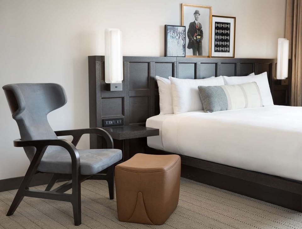 Recharge in a cozy seating corner beside your plush bed.