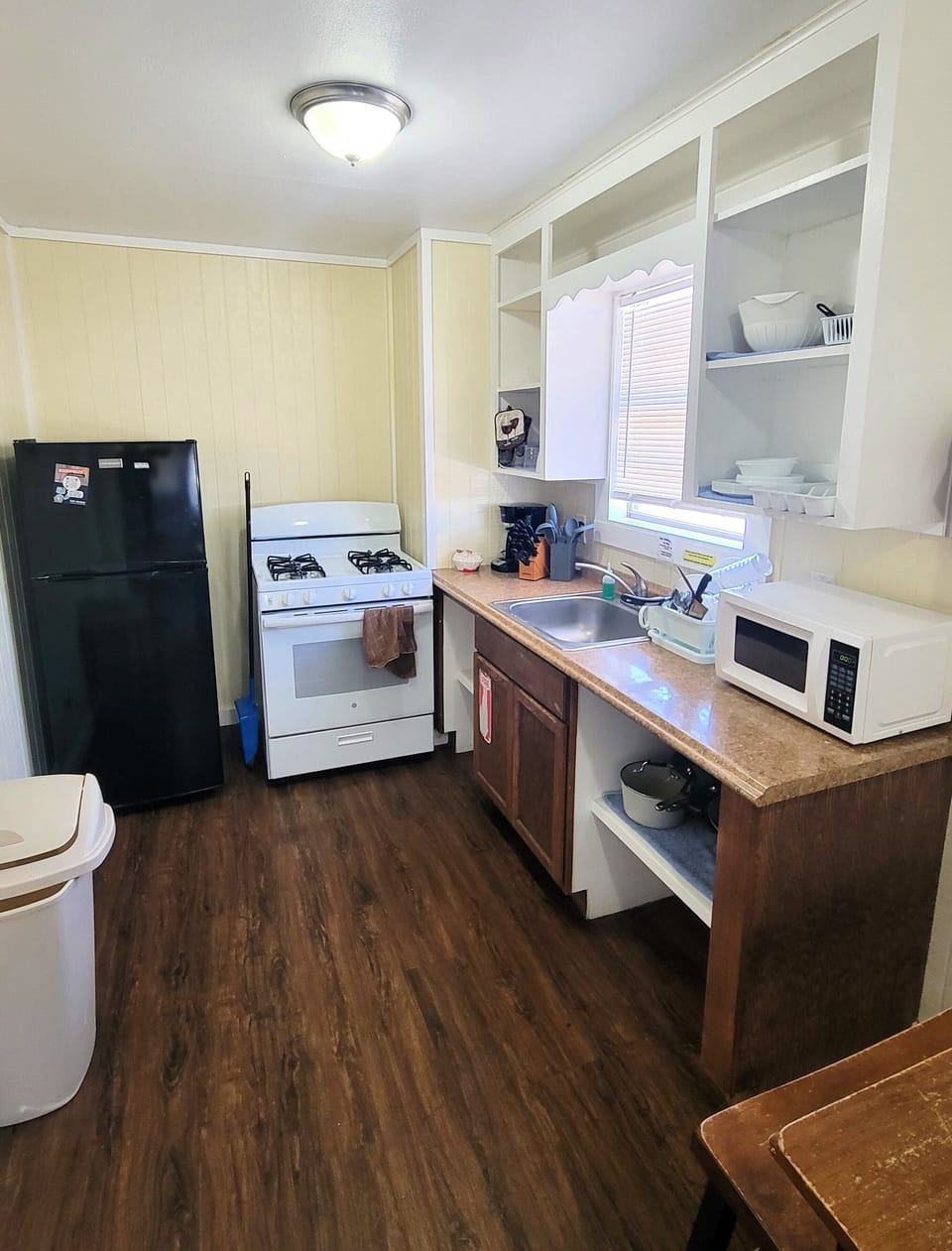 The kitchenette has a refrigerator, stove, microwave, and coffee maker.