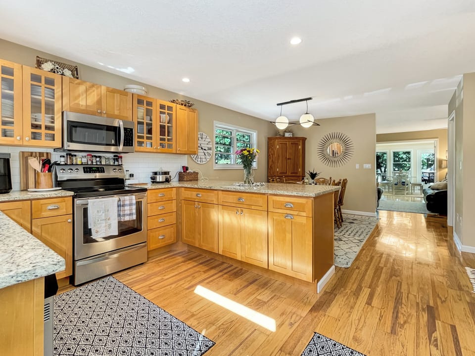 Fully stocked eat in Kitchen -looking into the living room and sunroom - main level