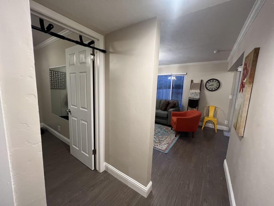 Hallway looking into living room & gym entrances