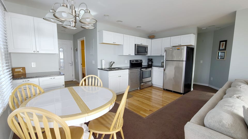 Main living area with dining table and kitchen