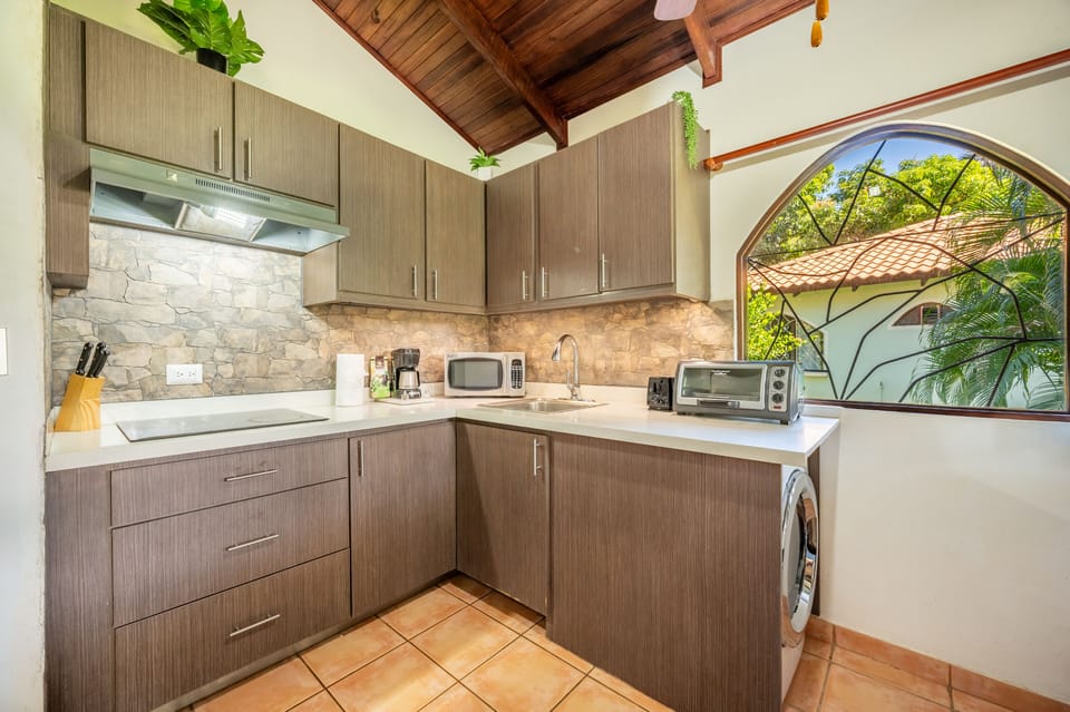 Tend to laundry needs in our space-efficient set up with a dual washer/dryer.