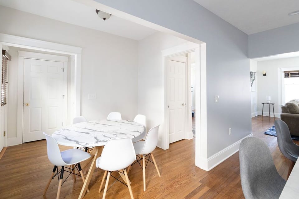 This dining room radiates style, with a sleek marble table and beautifully designed chairs.