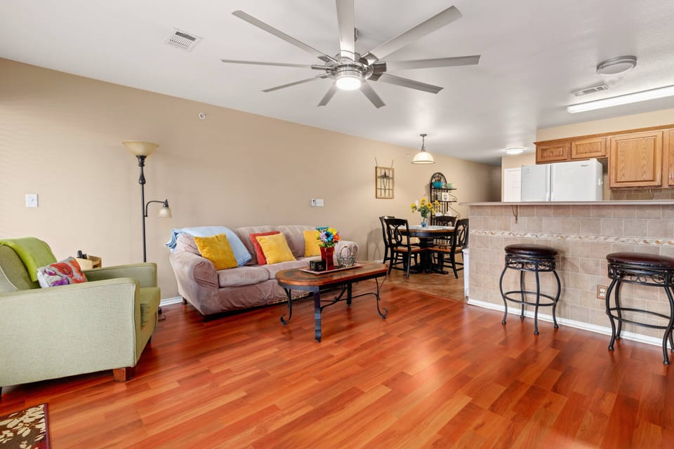 Bask in the warmth of the bright and inviting living room, adorned with stylish pops of color.