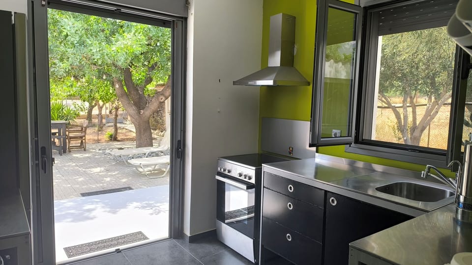 A balcony door connects the kitchen with the outdoor dining area.