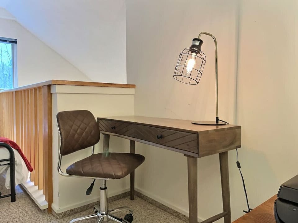 Rustic charm meets productivity in our wooden-inspired bedroom, with a cozy office table.