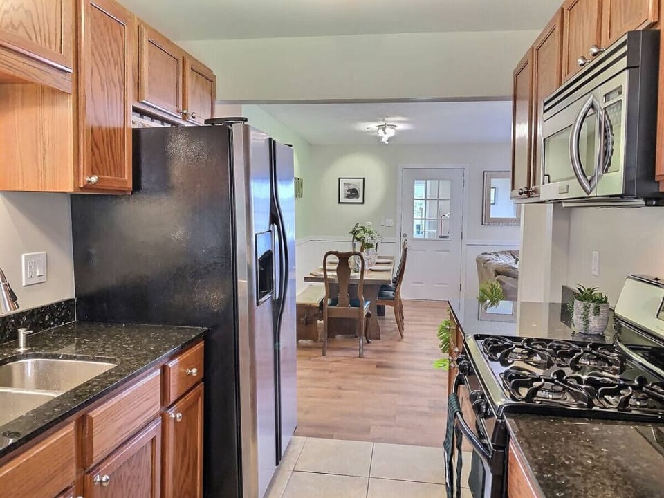 Discover the perfect fusion of rustic charm and modern convenience in our kitchen, adorned with stylish appliances.