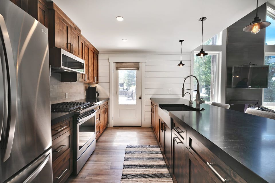 Kitchen offers modern appliances, is fully stocked with cookware and kitchen essentials, ample counter space & bar seating for guests.
