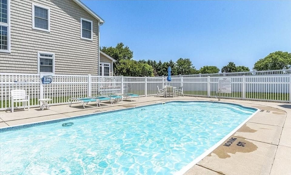 Community pool only steps away! Outdoor shower and bathroom on premise.