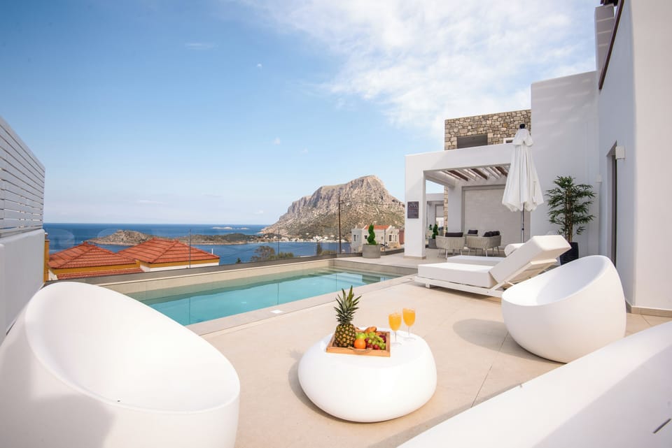 Sip drinks, soak up sun, and enjoy Telendos views.