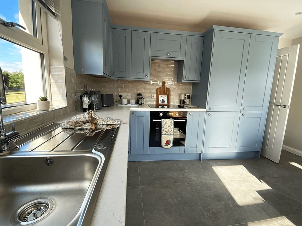 Spacious kitchen with all modern appliances and dining table  