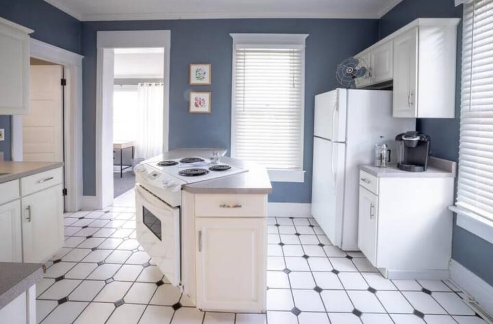 The kitchen island hosts an electric range/oven.