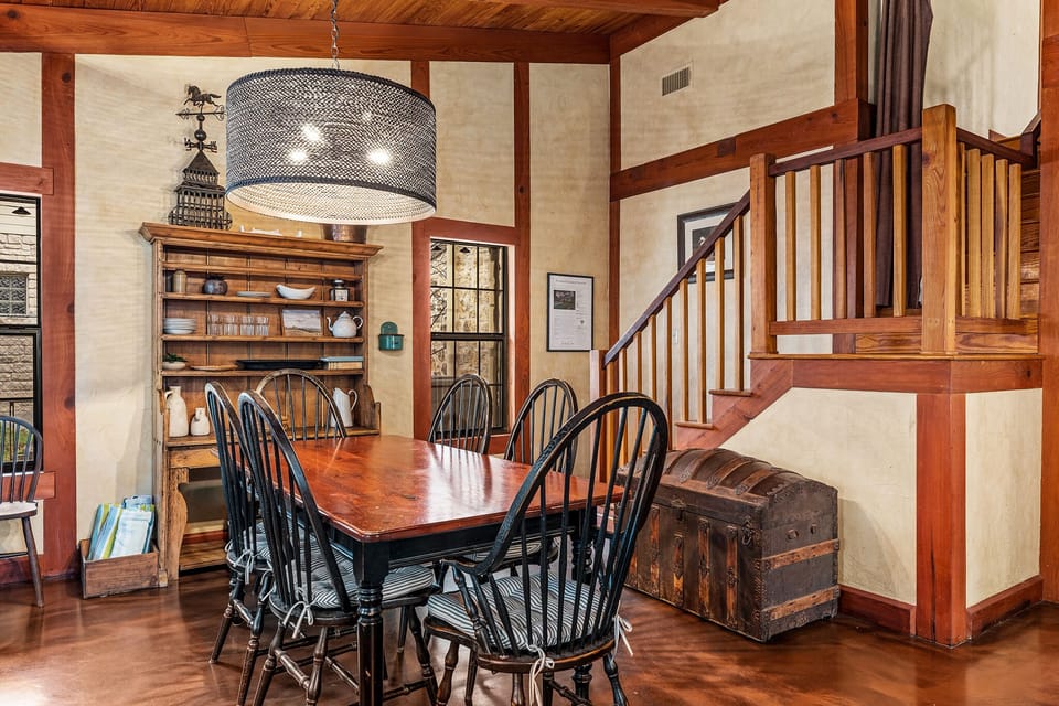 A charming wooden dining table with seating for six exudes rustic elegance.
