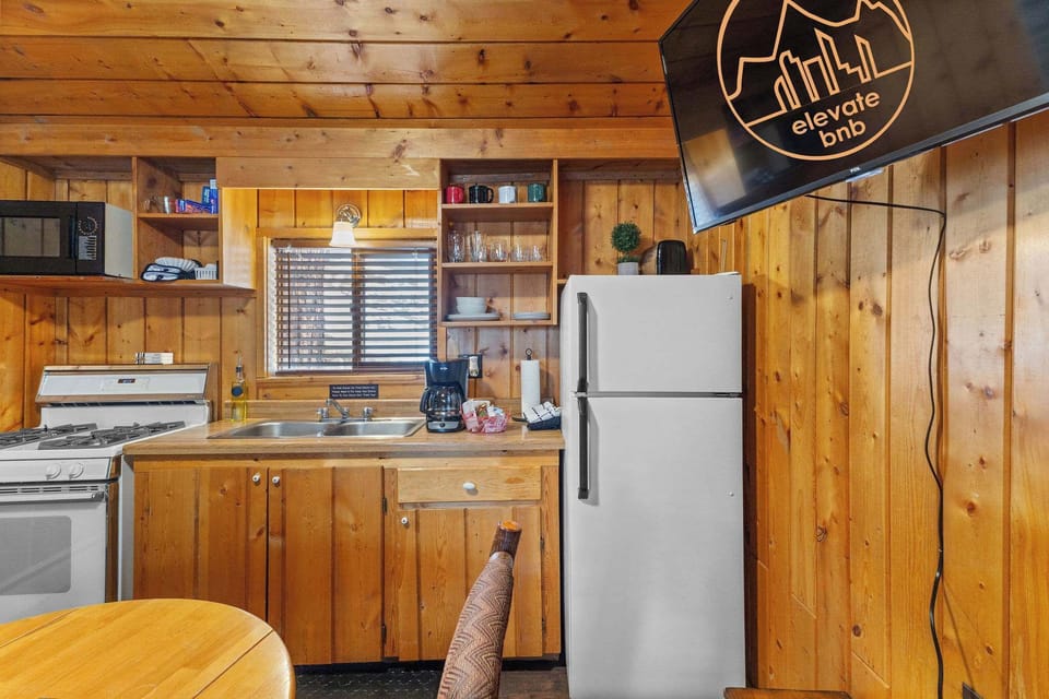 The kitchen has a stove, oven, refrigerator, microwave, toaster and of course, a coffee maker.