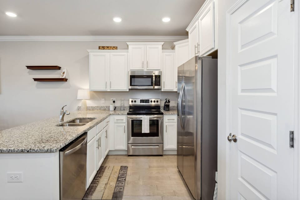 Fully equipped, modern kitchen with granite counters and stainless appliances