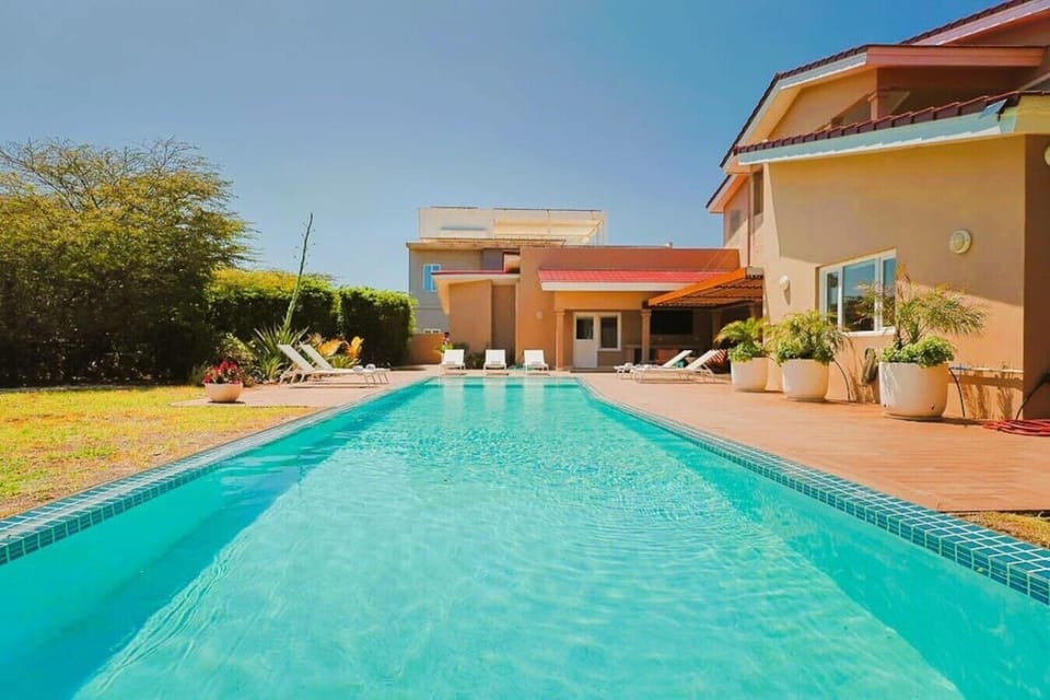 A stunning expansive landscaped private backyard garden, with your own large swimming pool, chaise sun loungers, BBQ, outside TV and a comfortable shaded patio terrace dining and seating area - a great space for enjoying time with family and friends.