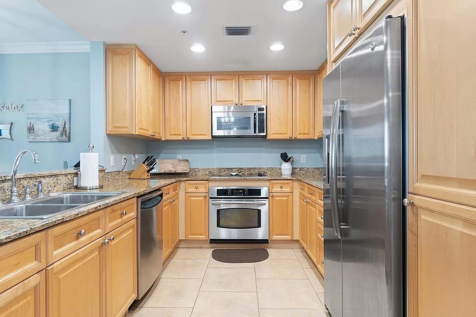 Fully stocked kitchen with stainless steel appliances. 