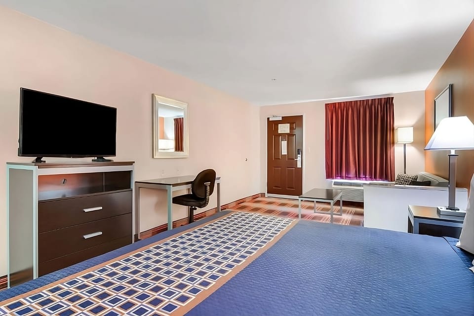 Settle in with TV entertainment and a simple work desk.