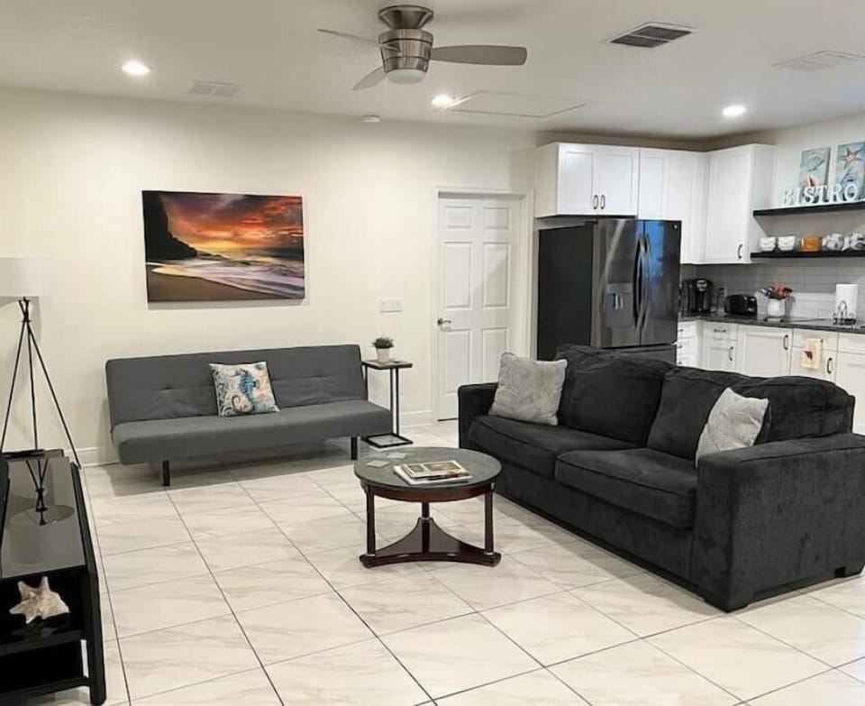 Main living room and secondary sleeping area with twin and queen sofa beds