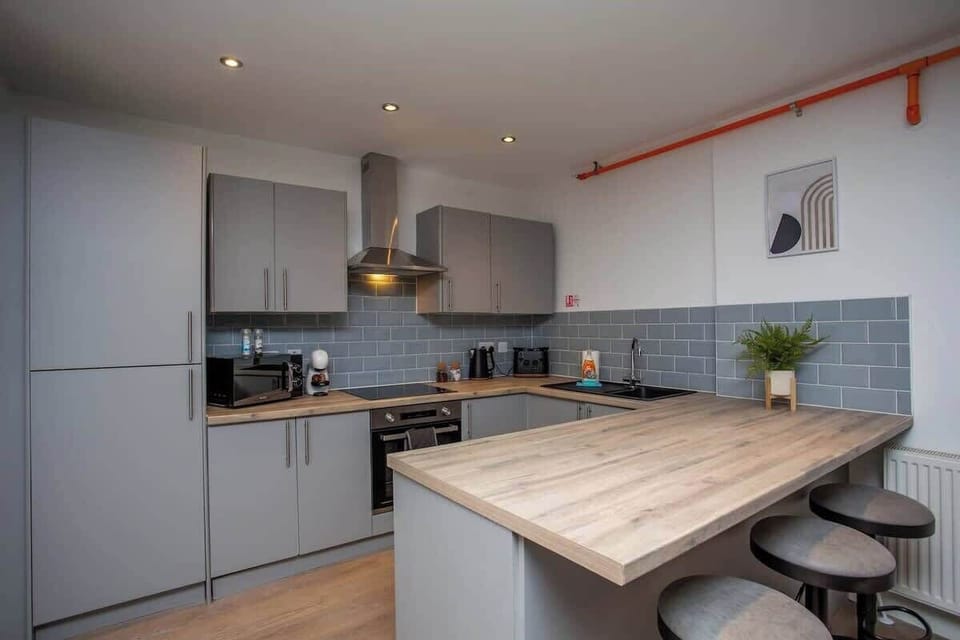 Nestled within this culinary oasis is a charming mini dining area, featuring a cozy three-seater table bathed in ambiance.