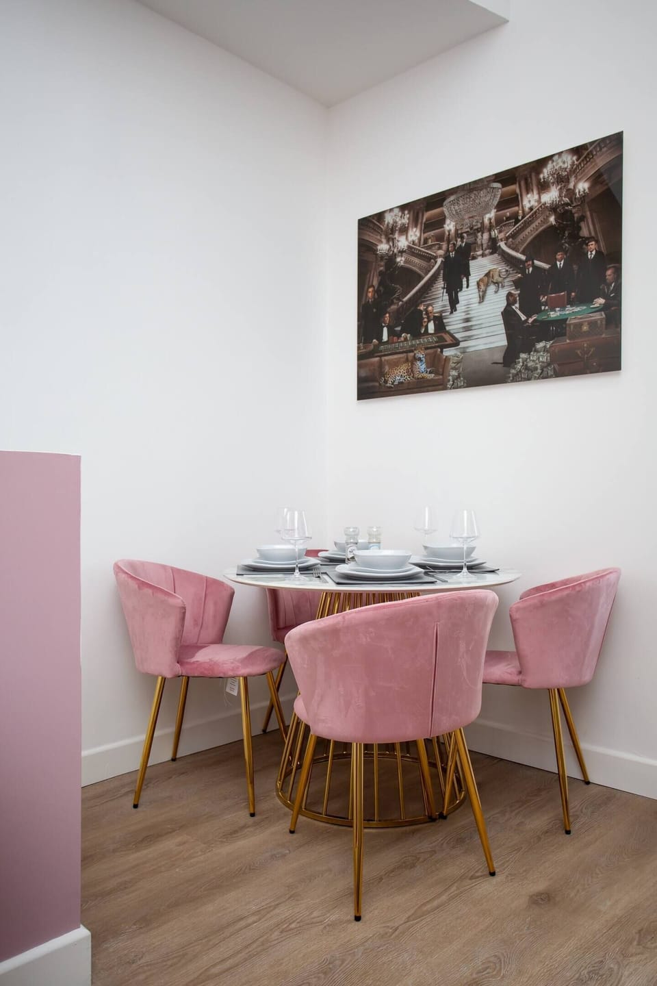  Gather with loved ones in the inviting dining area, where a sleek table for four awaits beneath the soft glow of lighting. 