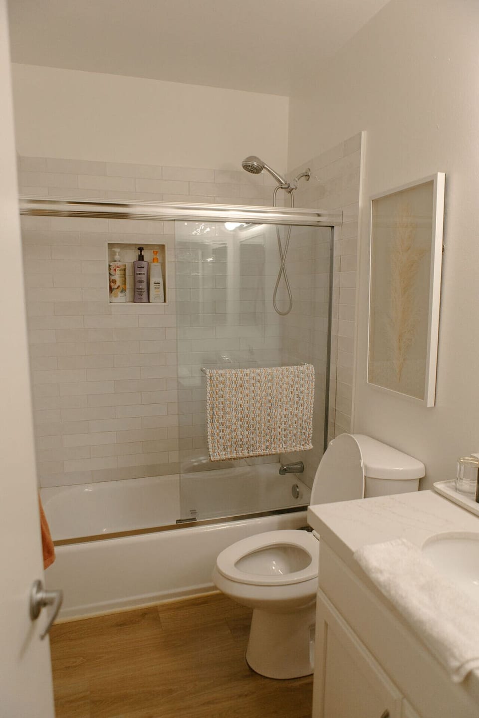 Newly remodeled bathroom featuring our tub/shower combo. We also have a hose just outside for rinsing off any sand after a beach day.