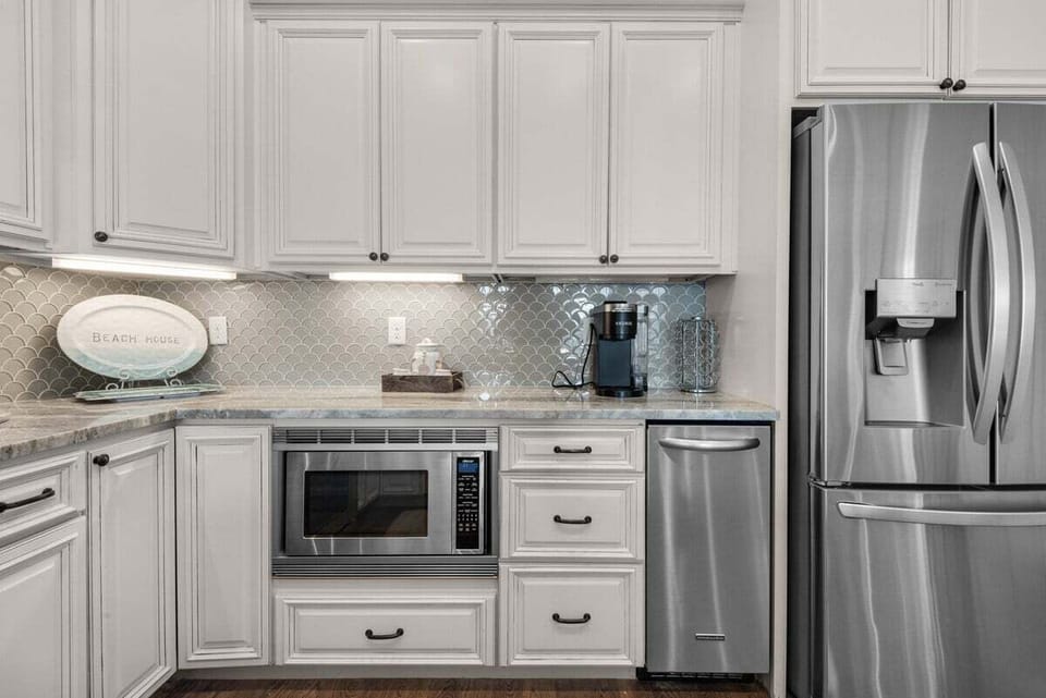 Discover the allure of this meticulously crafted kitchen featuring stunning granite countertops and an ice maker