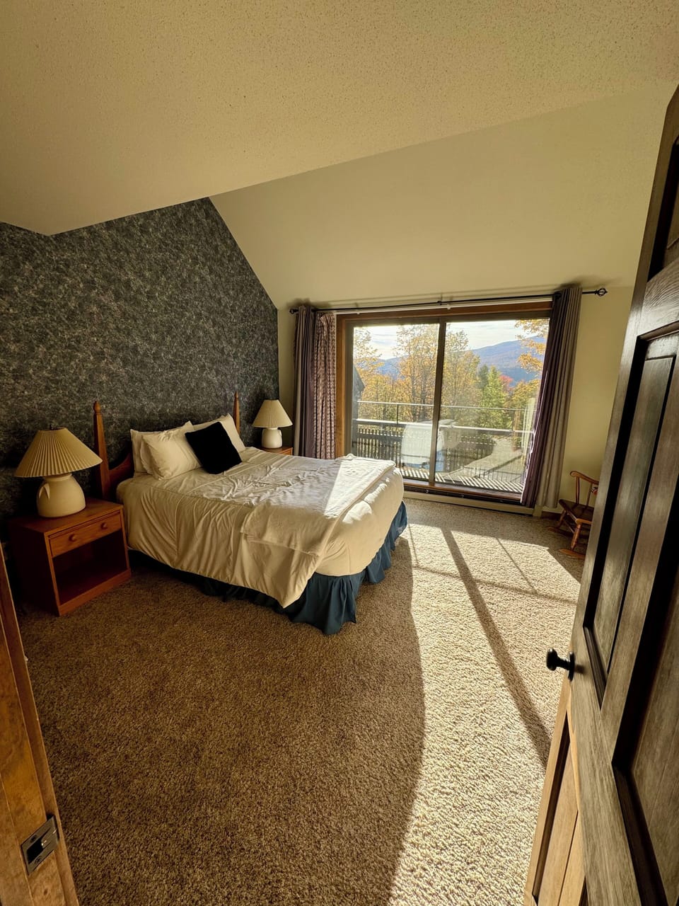 Upstairs queen bedroom with balcony and mountain view