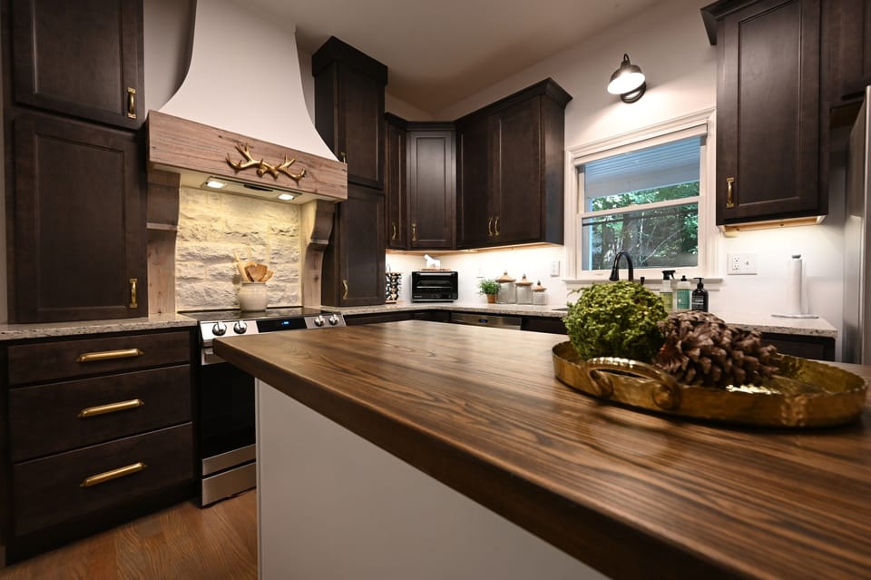 New cabinets feature dove-tailed drawers and are all soft close. Hood is custom designed and built; it features reclaimed wood from a church in Eastern North Carolina. 